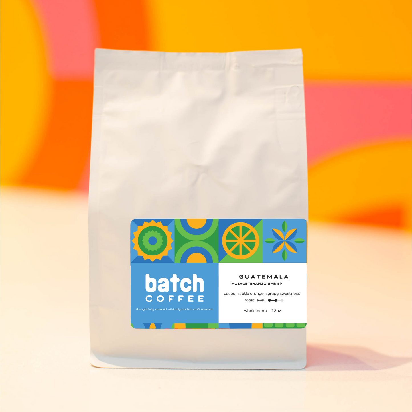Coffee bag with Batch Coffee label on a colorful abstract background